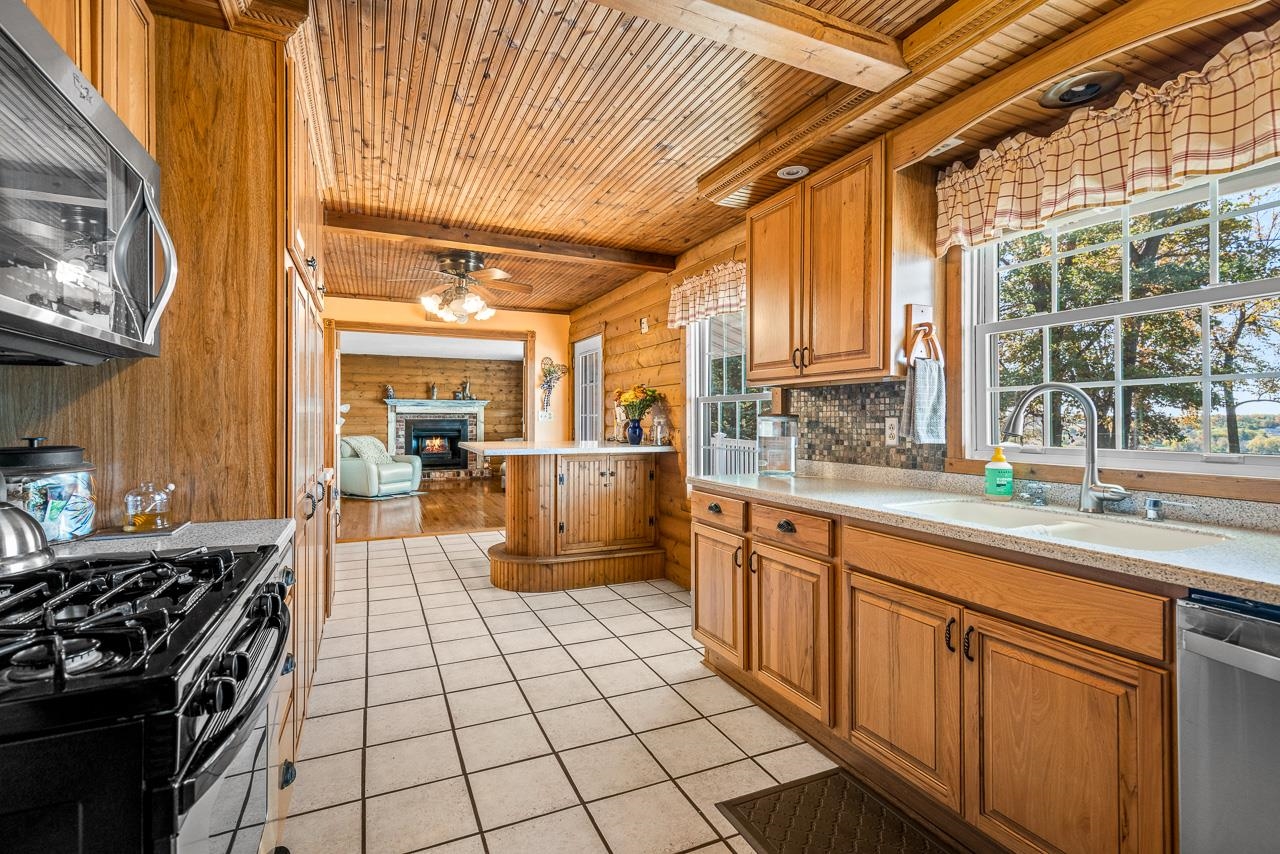 17097 Goodrich Road Davis, IL 61019 - Photo 10 of 45 a kitchen with stainless steel appliances granite countertop a stove a sink and a refrigerator