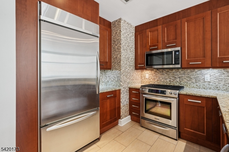 8100 River Road, Unit 210 North Bergen, NJ 07047 - Photo 11 of 25 a kitchen with granite countertop stainless steel appliances and granite counter tops
