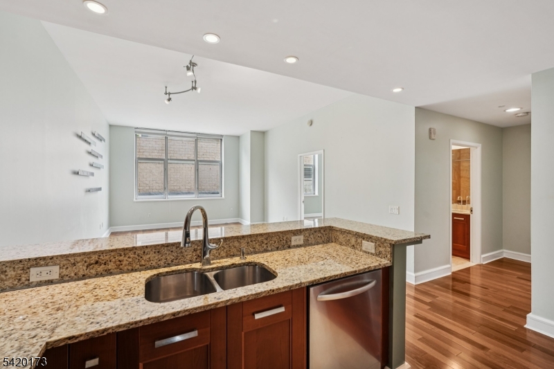 8100 River Road, Unit 210 North Bergen, NJ 07047 - Photo 12 of 25 a kitchen with a sink and a wooden floor
