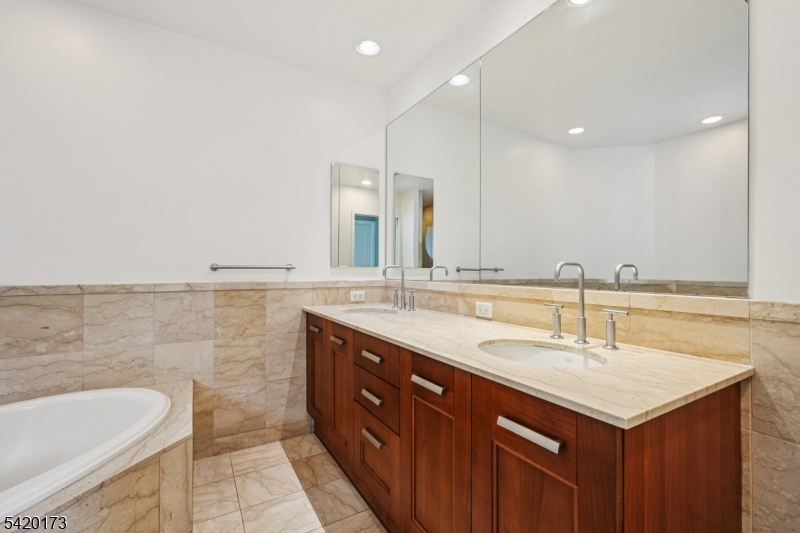 8100 River Road, Unit 210 North Bergen, NJ 07047 - Photo 16 of 25 a bathroom with a sink double vanity and a mirror
