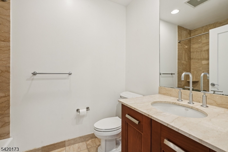 8100 River Road, Unit 210 North Bergen, NJ 07047 - Photo 18 of 25 a bathroom with a sink toilet and vanity