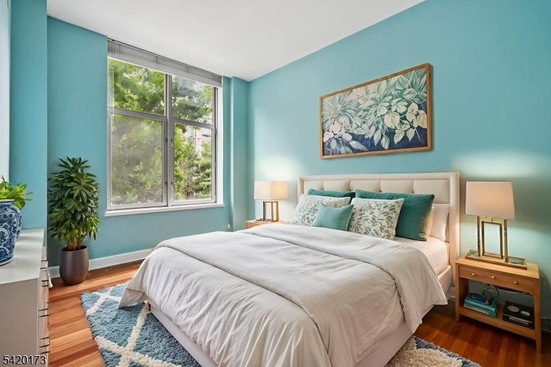 8100 River Road, Unit 210 North Bergen, NJ 07047 - Photo 19 of 25 a bedroom with a bed and a painting on the wall