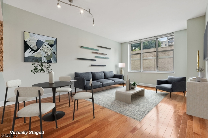 8100 River Road, Unit 210 North Bergen, NJ 07047 - Photo 2 of 25 a living room with furniture and wooden floor