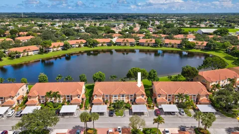 an aerial view of residential houses with outdoor space and lake view