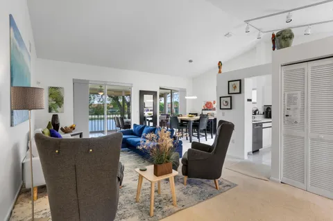 a living room with furniture a dining table and a sink