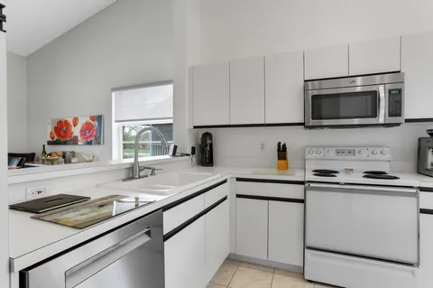 a kitchen with a sink and white cabinets