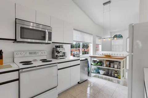 a kitchen with stainless steel appliances a sink and a cabinets