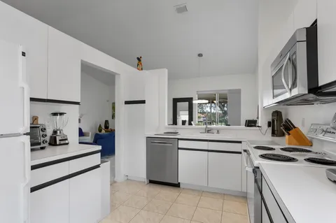 a kitchen with stainless steel appliances a sink stove and refrigerator