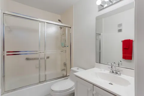 a bedroom with a bed and ceiling fan