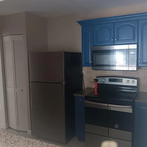 a kitchen with appliances and cabinets