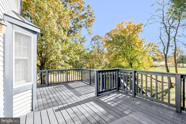 a view of balcony with wooden floor and fence
