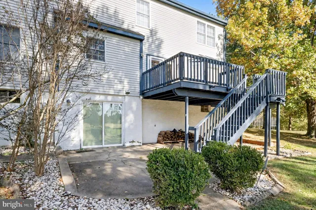 a view of a house with a small yard and wooden fence