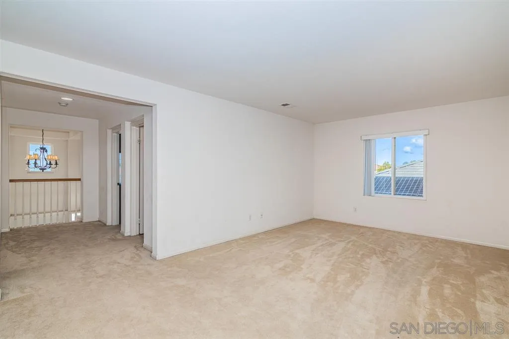 3506 Rock Ridge Road Carlsbad, CA 92010 - Photo 14 of 25 an empty room with windows and entrance to other room