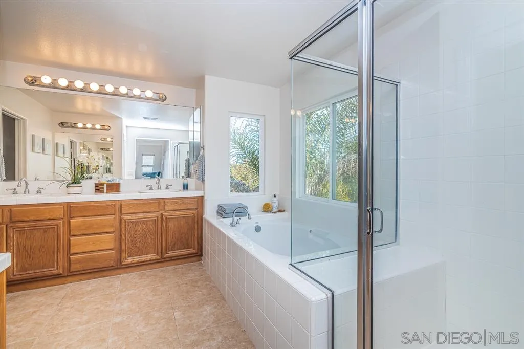 3506 Rock Ridge Road Carlsbad, CA 92010 - Photo 18 of 25 a large bathroom with a large tub sink and shower