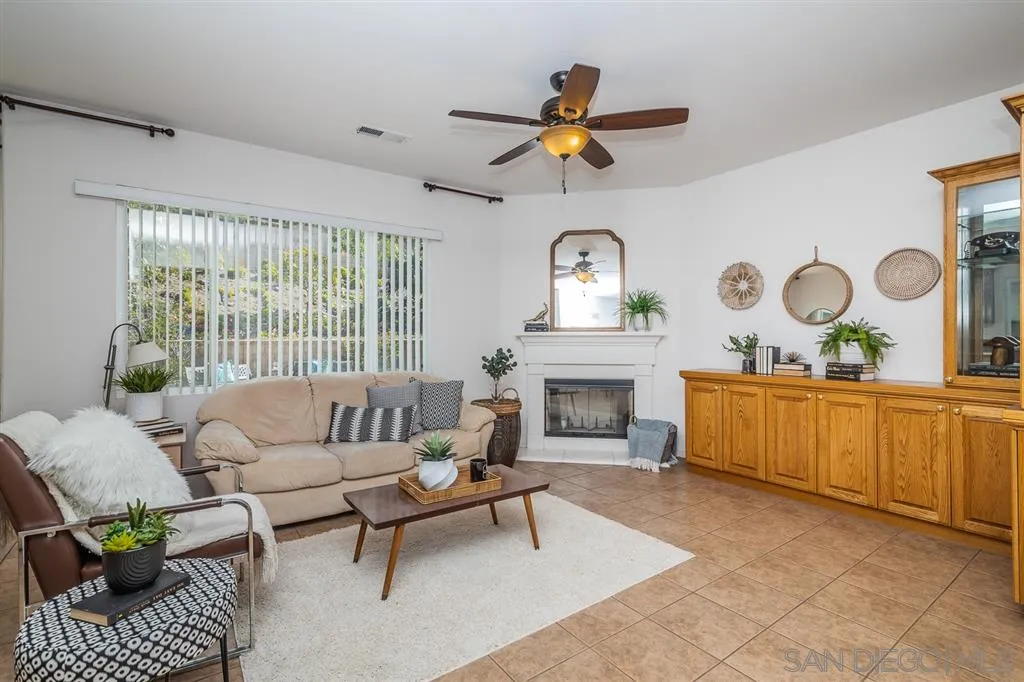3506 Rock Ridge Road Carlsbad, CA 92010 - Photo 8 of 25 a living room with furniture and a fireplace