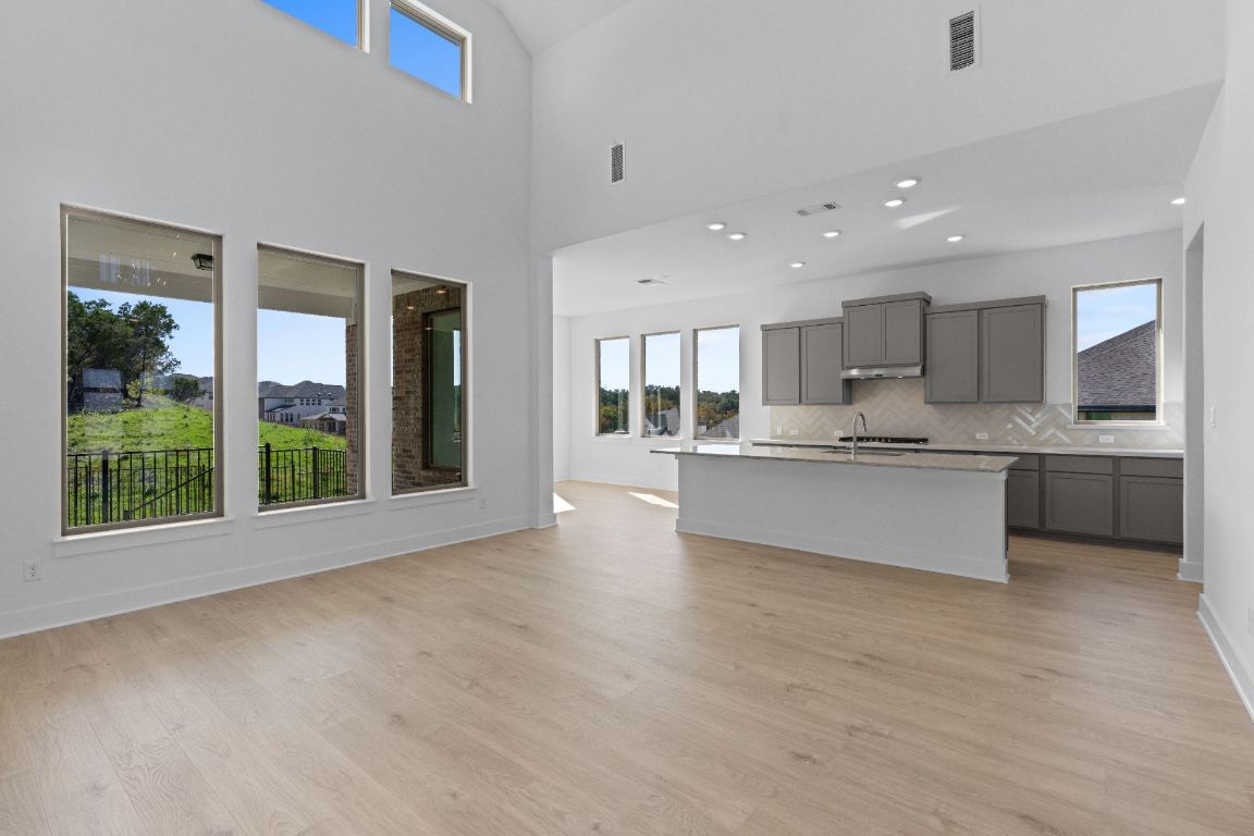 1409 Treasure Map View Leander, TX 78641 - Photo 15 of 40 From Family Room to Open Concept Kitchen