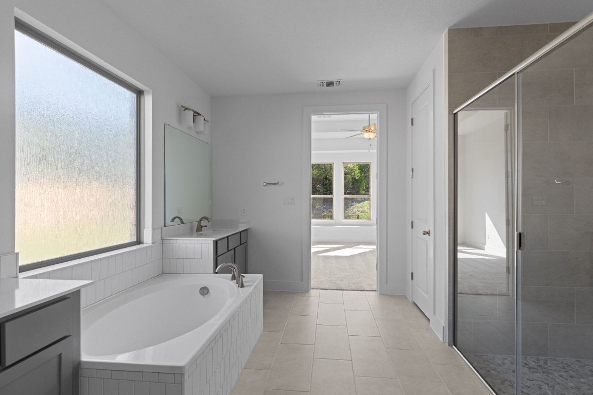 1409 Treasure Map View Leander, TX 78641 - Photo 23 of 40 Primary Bath retreat with dual vanities & garden tub