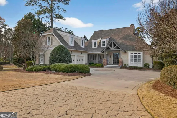 a front view of a house with a yard and a garage