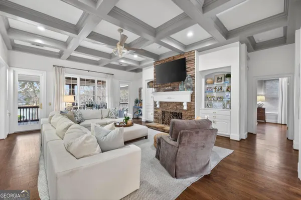 a kitchen with stainless steel appliances a sink cabinets and a wooden floor