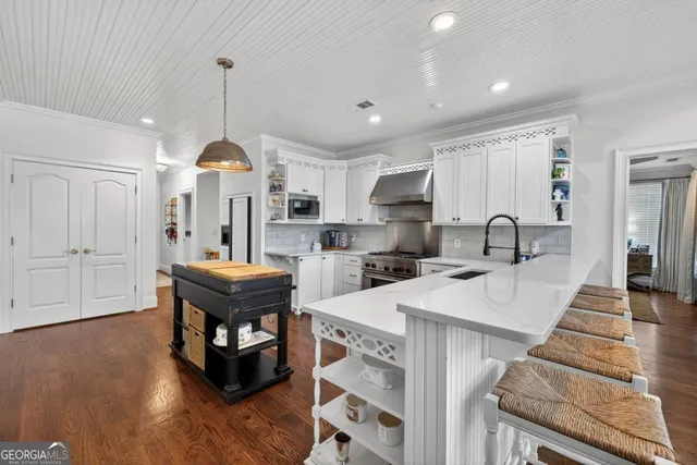a living room with kitchen island furniture and a table