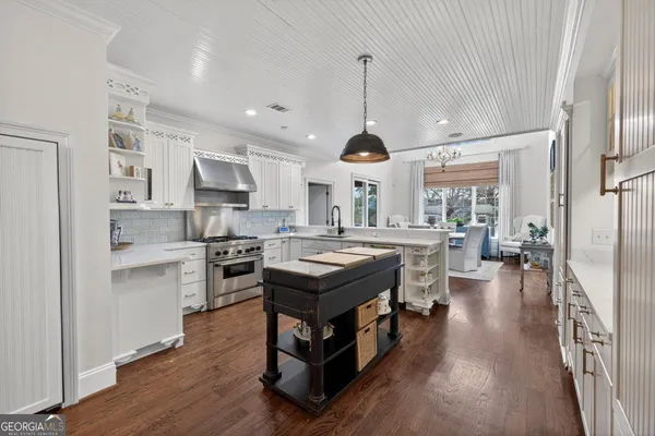 a living room with a balcony furniture and a large window