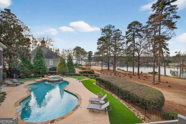 an aerial view of a house with a yard and lake view