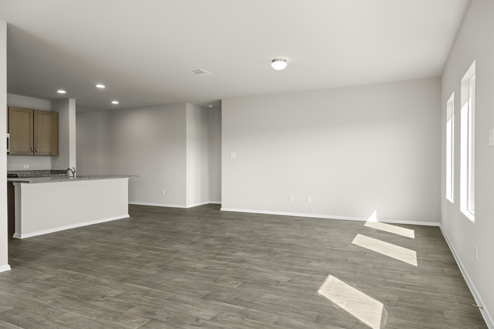 5509 Sacra Cove Austin, TX 78747 - Photo 17 of 38 an empty room with wooden floor and windows
