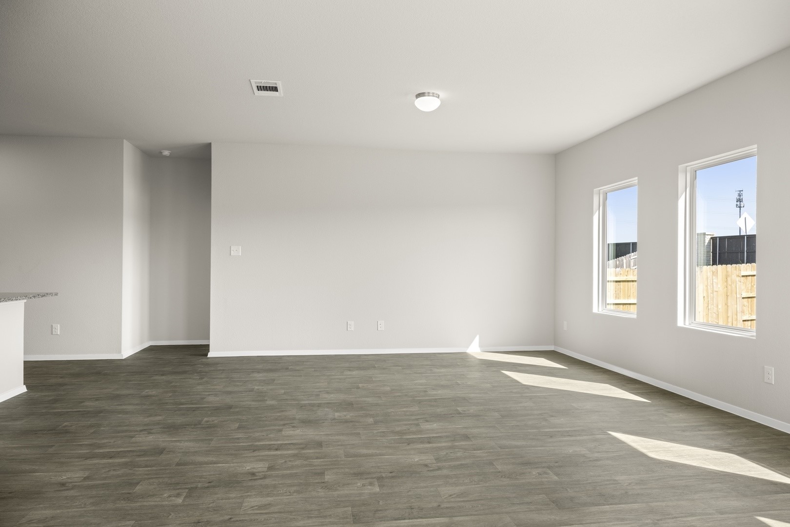 5509 Sacra Cove Austin, TX 78747 - Photo 18 of 38 a view of an empty room with wooden floor and a window