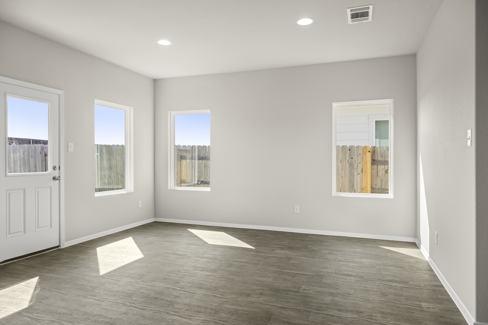 5509 Sacra Cove Austin, TX 78747 - Photo 19 of 38 wooden floor in an empty room with a window
