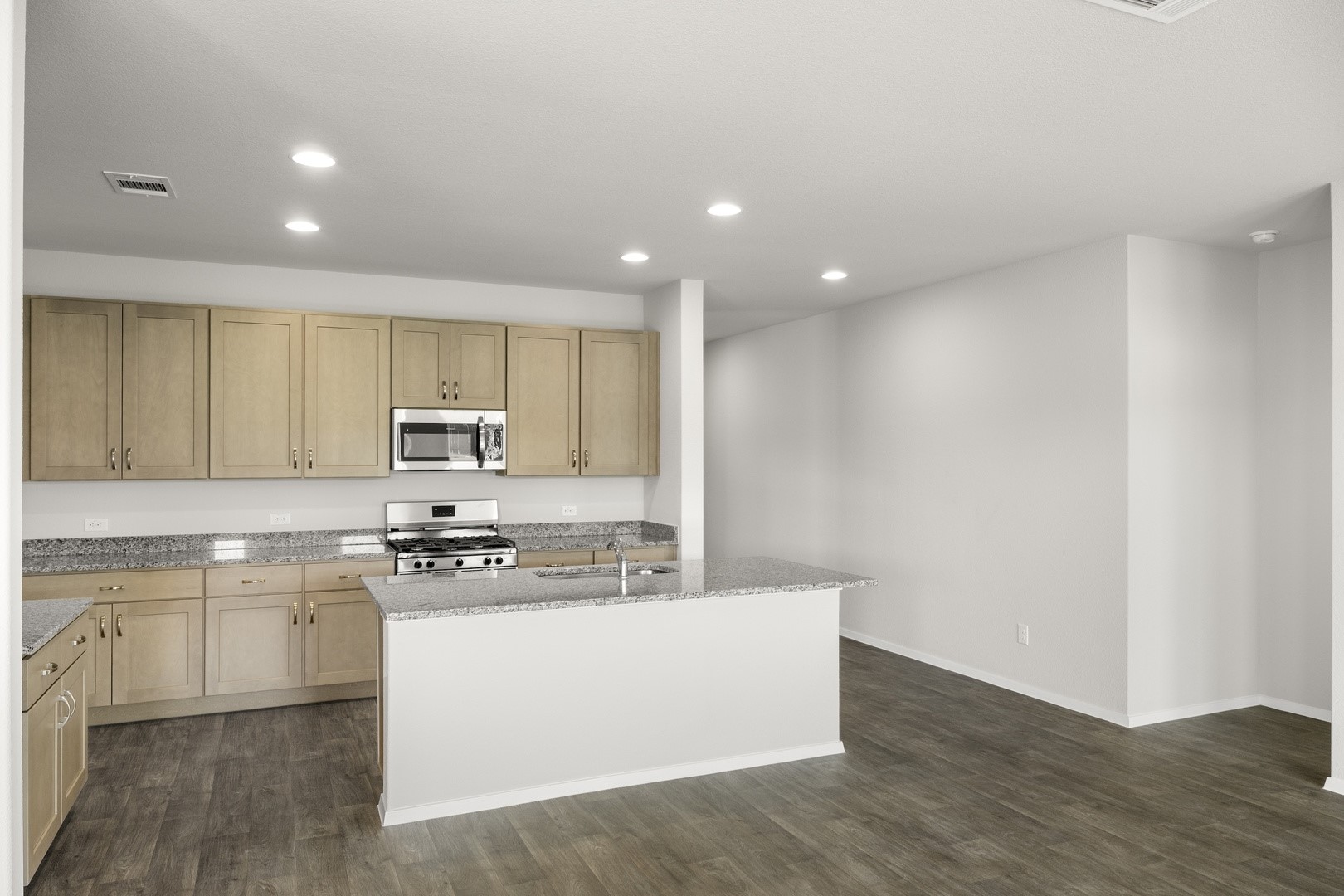 5509 Sacra Cove Austin, TX 78747 - Photo 22 of 38 a kitchen with stainless steel appliances a sink a stove a refrigerator and cabinets