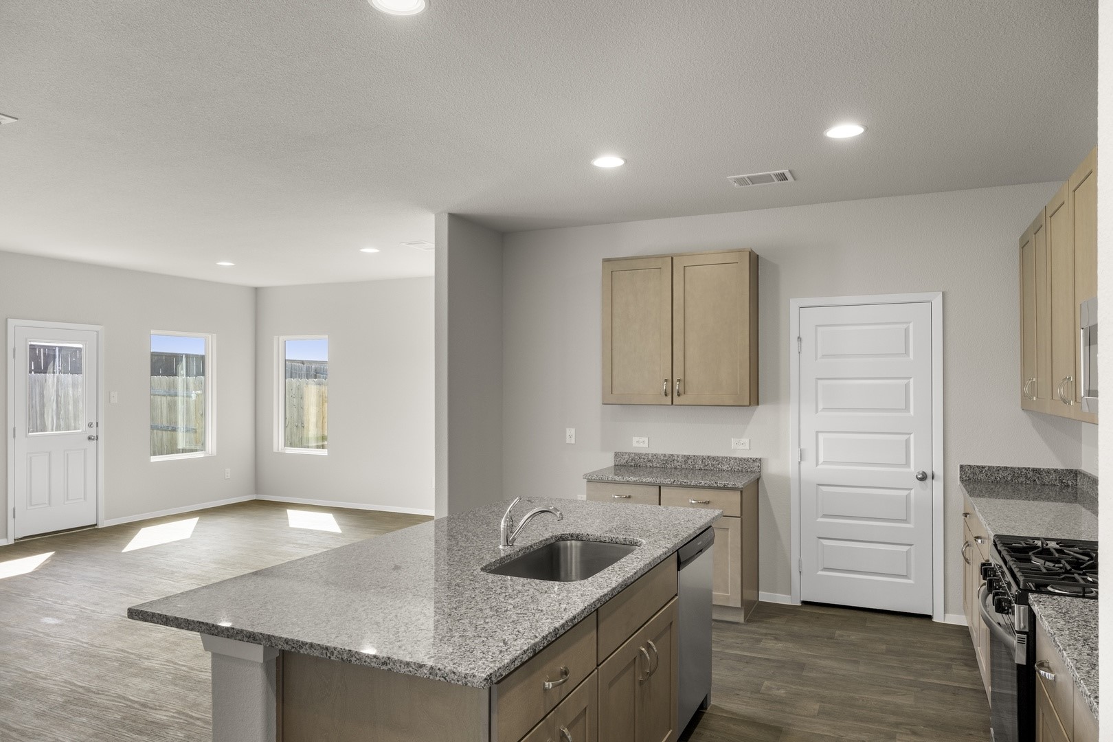 5509 Sacra Cove Austin, TX 78747 - Photo 24 of 38 a kitchen with granite countertop a sink and a stove top oven