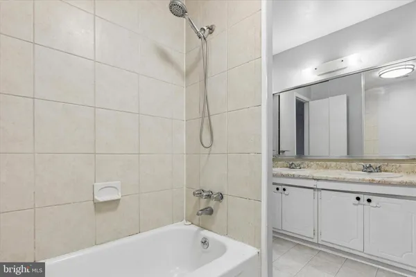 a bathroom with a granite countertop sink a toilet and shower