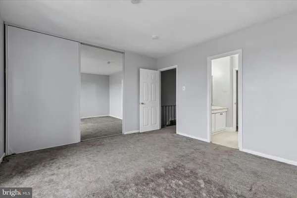 a view of an empty room and closet area