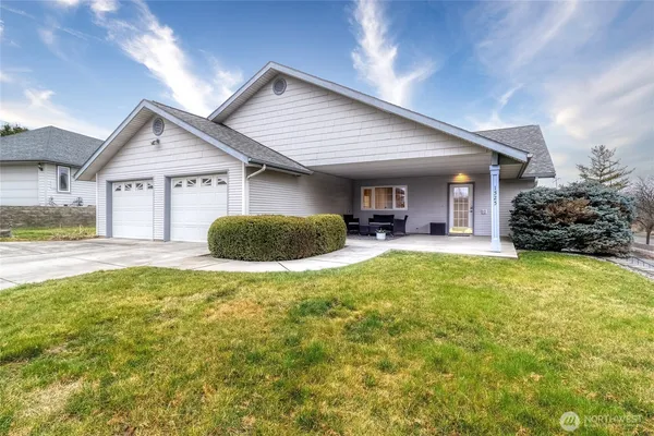 a front view of house with yard and outdoor seating