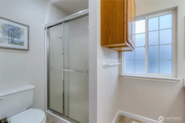 a bathroom with a toilet and a shower