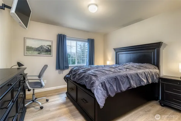 a bedroom with a bed and a desk