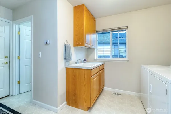 a view of entrance and kitchen with wooden floor