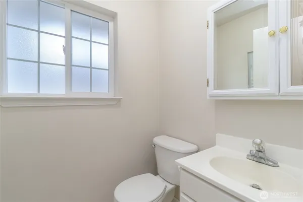 a white toilet sitting next to a bathroom sink