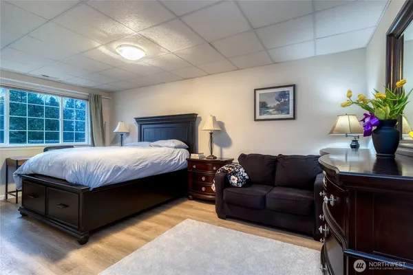 a bedroom with a bed couch and window