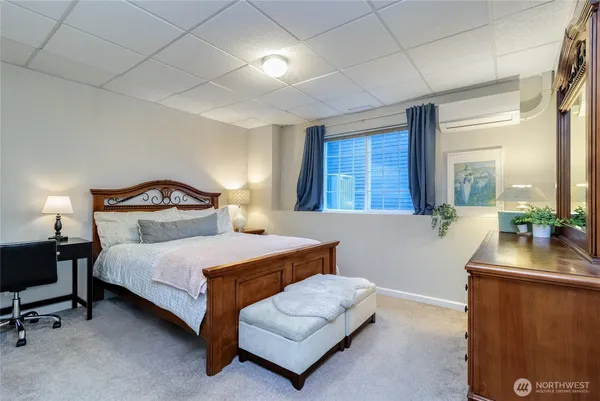 a bedroom with a bed and a night stand