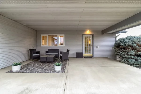 a view of a patio with table and chairs and potted plants
