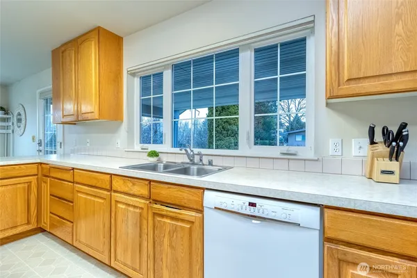 a kitchen with granite countertop sink and window