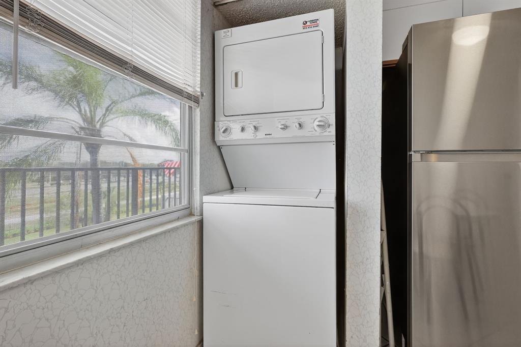 650 Southwest 124th Terrace, Unit 404P Pembroke Pines, FL 33027 - Photo 12 of 26 a utility room with dryer and washer