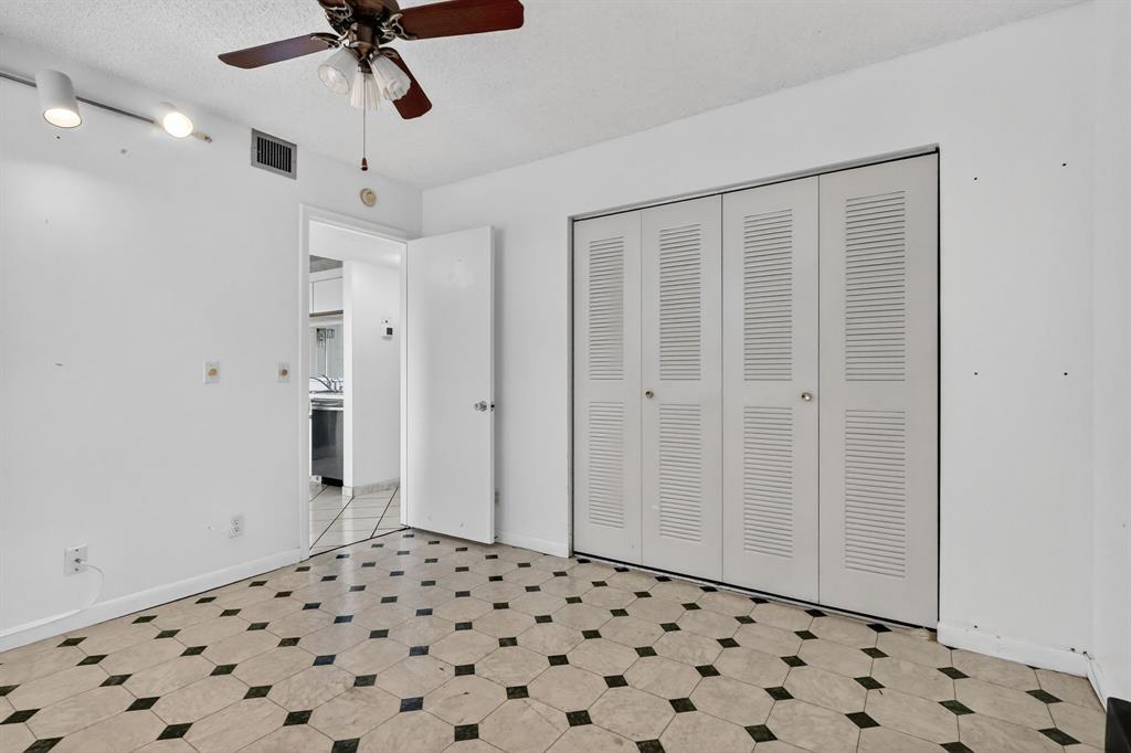 650 Southwest 124th Terrace, Unit 404P Pembroke Pines, FL 33027 - Photo 18 of 26 a view of a hallway with a cabinet