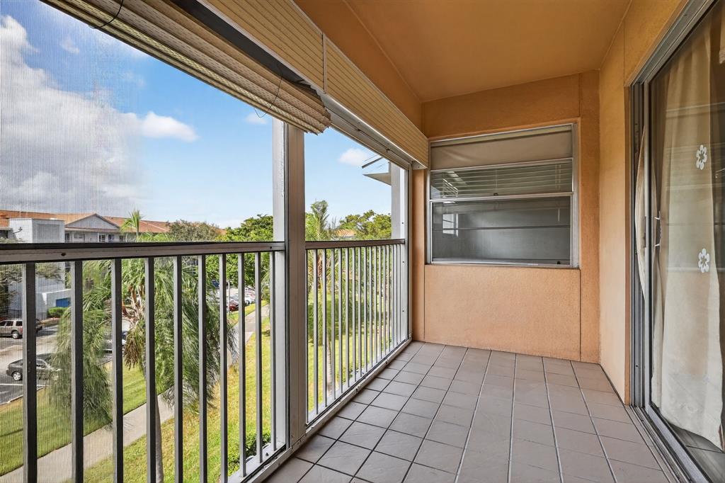 650 Southwest 124th Terrace, Unit 404P Pembroke Pines, FL 33027 - Photo 25 of 26 a view of a balcony with wooden floor
