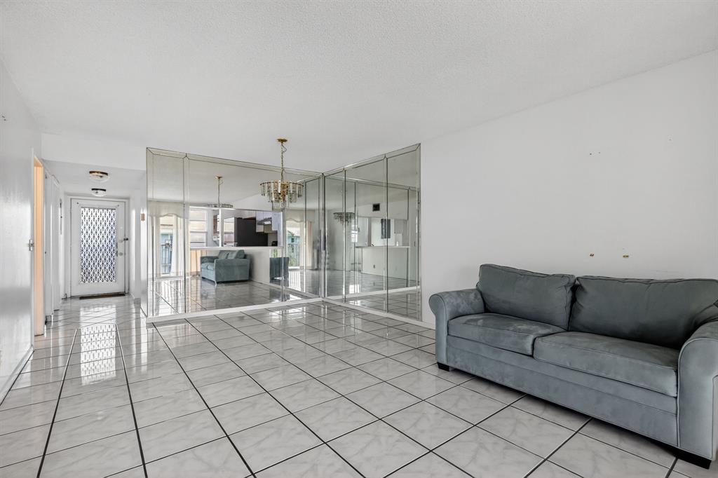 650 Southwest 124th Terrace, Unit 404P Pembroke Pines, FL 33027 - Photo 5 of 26 a living room with furniture and a chandelier