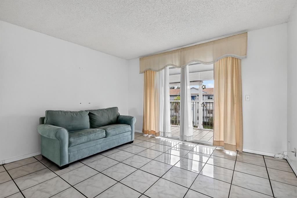 650 Southwest 124th Terrace, Unit 404P Pembroke Pines, FL 33027 - Photo 6 of 26 a living room with furniture and a window