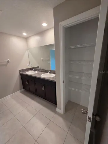 a bathroom with a sink a vanity and a mirror