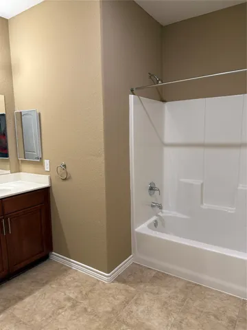 a bathroom with a bathtub and a sink