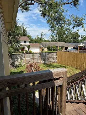 a view of a patio with wooden fence